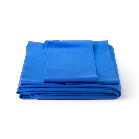 Folded blue pool table cloth set on a white background