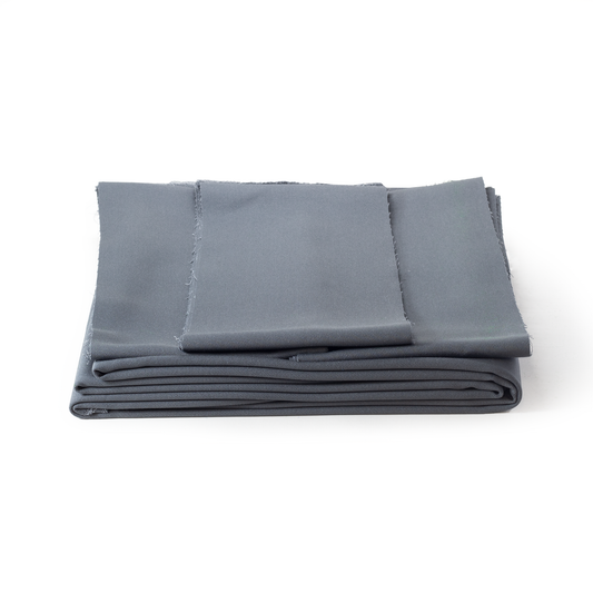 Folded grey pool table fabric on a white background