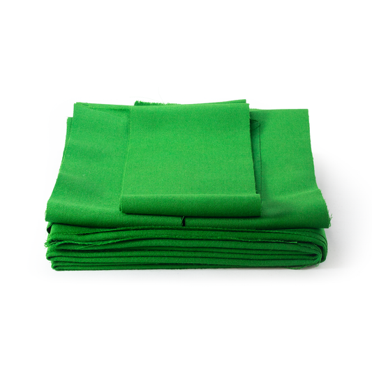 Stack of green pool cloth fabric on a white background