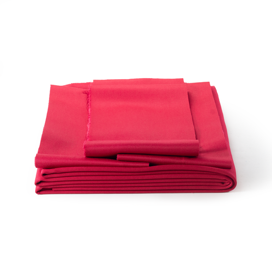 Folded red pool table fabric on a white background