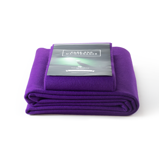 Hainsworth-SMART folded purple pool table cloth with a care and maintenance card on a white background