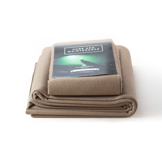 Hainsworth-SMART Folded beige pool table cloth blanket with a label on a white background