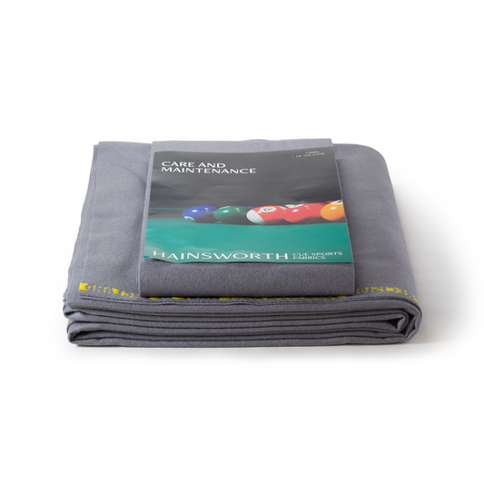 Folded gray fabric with Hainsworth care and maintenance guide on a white background