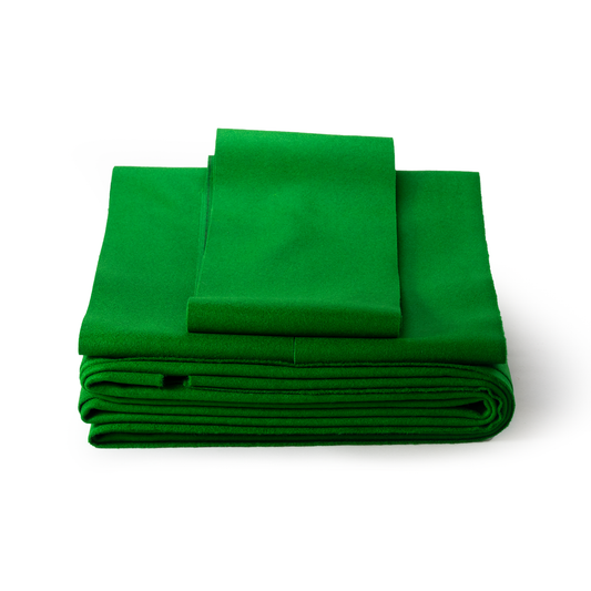 Green folded pool table fabric on a white background